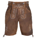 A pair of brown leather traditional Lederhosen with white embroidered floral patterns and silver metal grommets on the waistband, shown against a plain white background.