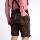 Men wearing dark brown leather or suede lederhosen shorts with suspenders, paired with a red and white gingham shirt, shown from the back against a plain white background.