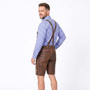 A man wearing brown leather traditional Lederhosen with brown suspenders, a blue and white checkered shirt, and brown suspenders, photographed from the back against a white studio background.