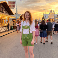 Model wearing Womens Oktoberfest Outfit Lederhosen Suede Leather Oktoberfest Dress Green with traditional embroidered suspenders