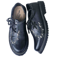 Top-down view of Gentry Choice Bavarian shoes showing branded insole and embroidered toe design