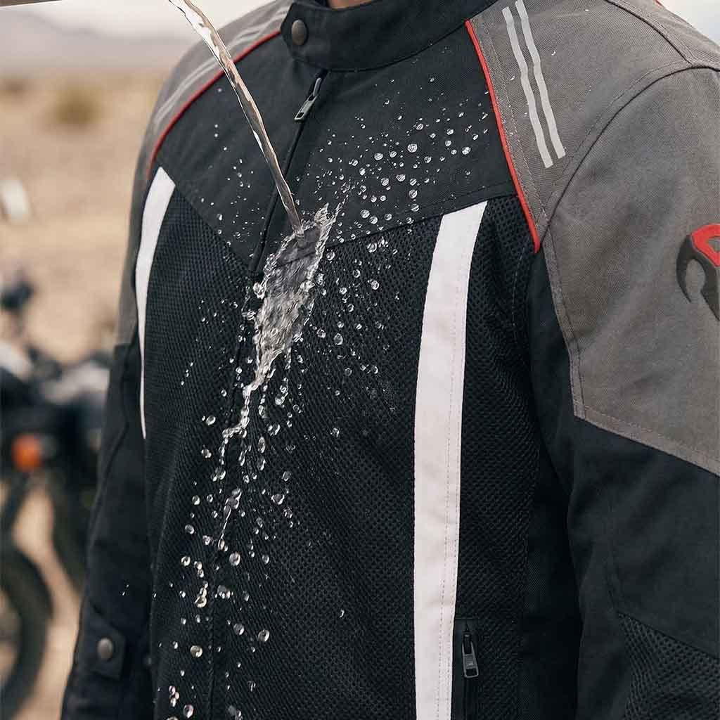 Men wearing a jacket with water droplets on it, with a blurred background of a desert landscape.