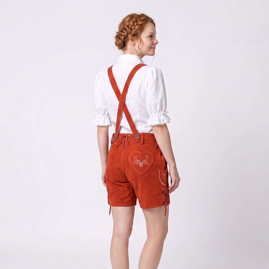Model wearing Womens Red Suede Leather Lederhosen Oktoberfest Outfit showing crossed suspenders and embroidered heart back pocket