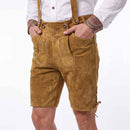 A person wearing tan suede-like lederhosen shorts with embroidered details, suspenders, and front patch pockets, paired with a white shirt against a plain white background.