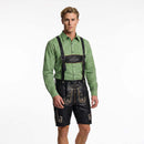 A man modeling traditional Bavarian attire, featuring a green and white checkered long-sleeve shirt, black leather suspenders with a black leather chest piece, and black leather embroidered lederhosen shorts, against a plain white background.