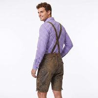 A man wearing brown leather-like suspenders over a purple and white checkered shirt, shown from the back against a plain white studio background.