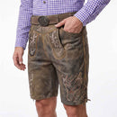 A man wearing distressed brown leather western-style shorts with embroidered details, a brown belt with a large round buckle, and a purple-and-white checkered shirt, shown from the waist down against a white background.