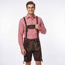 A man modeling traditional Bavarian attire, featuring a red and white gingham long-sleeve shirt paired with dark brown leather Lederhosen with embroidered details and suspenders, set against a plain white studio background.