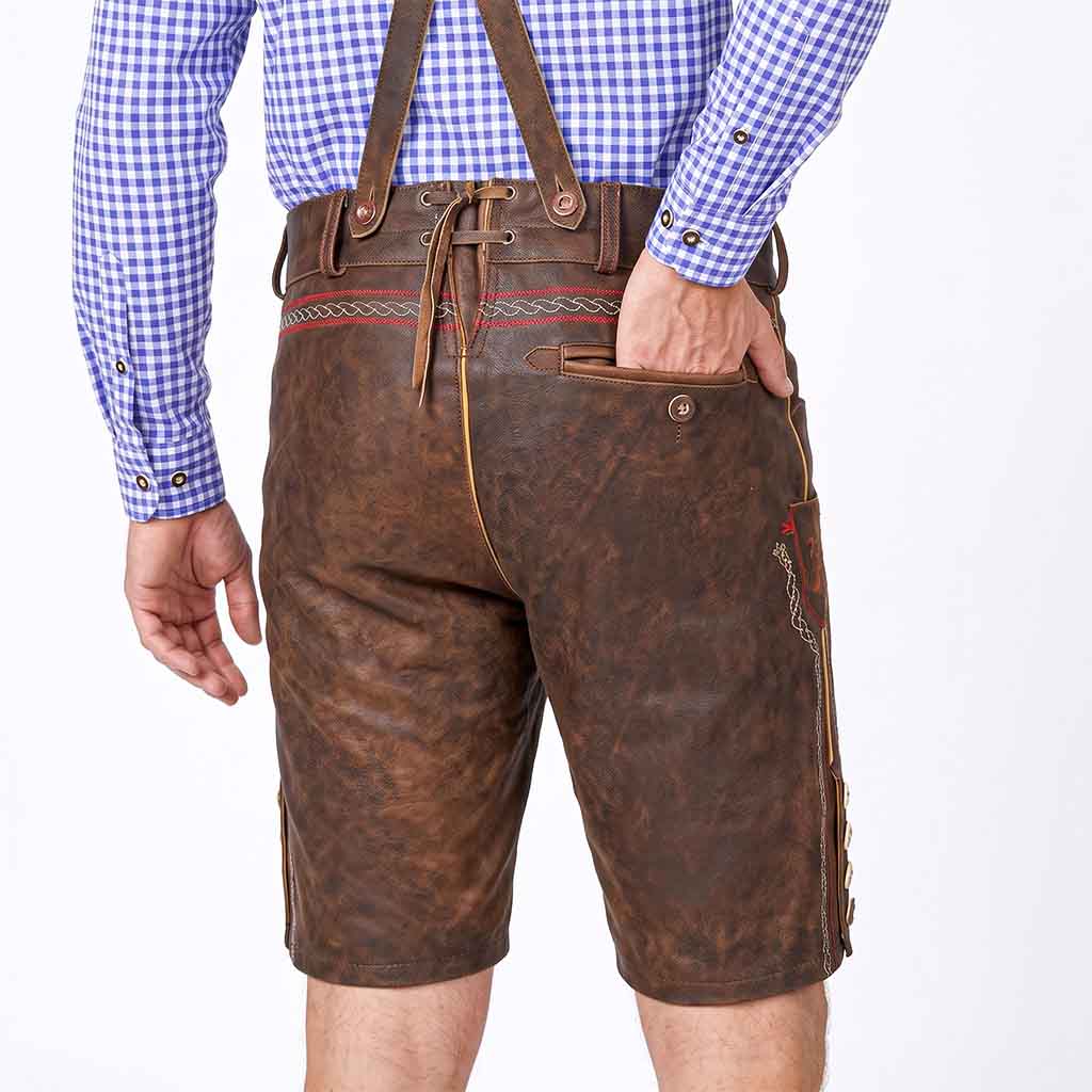 Rear view of a person wearing brown leather traditional Lederhosen with suspenders, a blue and white gingham shirt, and bare legs against a white studio background.
