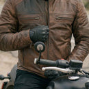 Close-up detail of RIDERACT leather motorcycle jacket zipper and front pocket design