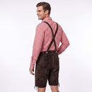 A man wearing a red and white gingham long-sleeve shirt and dark brown Lederhosen with suspenders, shown from a three-quarters back view against a white studio background.