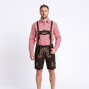 A man modeling traditional Bavarian attire consisting of dark brown suede lederhosen with embroidered details and suspenders, paired with a red and white gingham long-sleeve shirt, against a plain white studio background.
